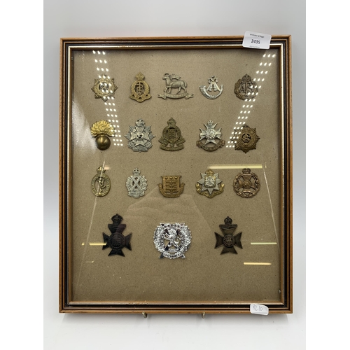 2435 - Eighteen framed military cap badges