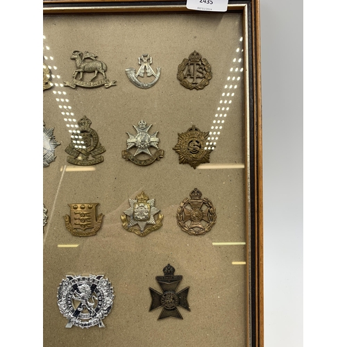 2435 - Eighteen framed military cap badges