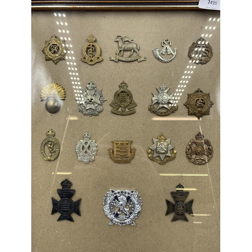 2435 - Eighteen framed military cap badges