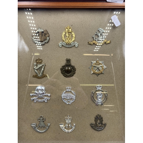 2437 - Twelve framed military cap badges