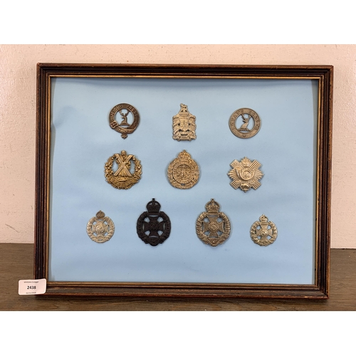 2438 - Ten framed military cap badges