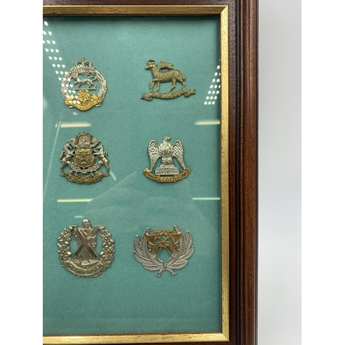 2440 - Nine framed Scottish Regiment military cap badges