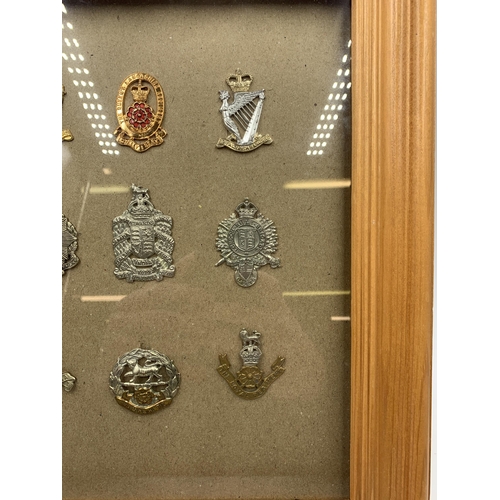 2442 - Nine framed military cap badges