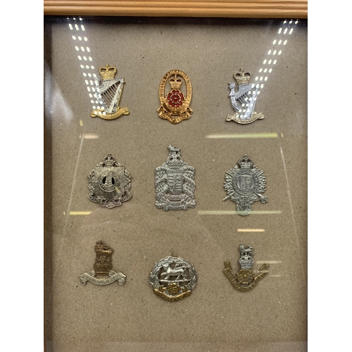 2442 - Nine framed military cap badges