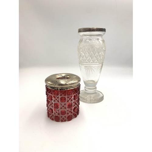 2380 - Two pieces of cut glassware with hallmarked sterling silver tops, one cranberry jar and one clear fo... 