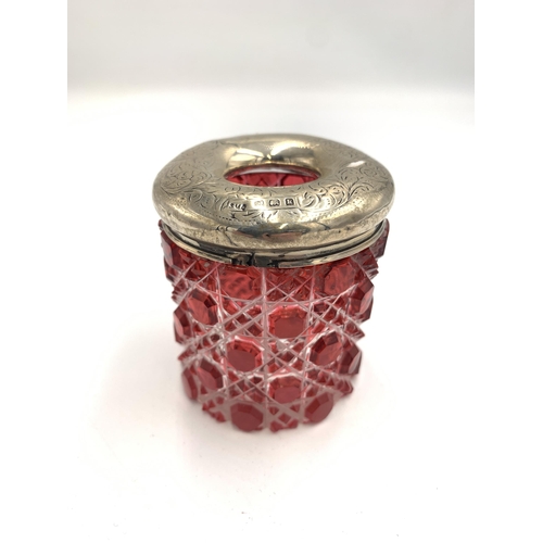 2380 - Two pieces of cut glassware with hallmarked sterling silver tops, one cranberry jar and one clear fo... 