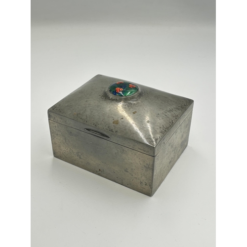 2456 - A pewter cigarette box with enamel roundel and wooden lining, inscribed '0851 English pewter' in the... 