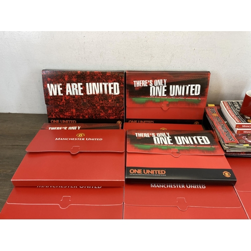 559 - A collection of Manchester United memorabilia comprising membership packs, magazines, year books and... 