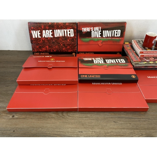 559 - A collection of Manchester United memorabilia comprising membership packs, magazines, year books and... 