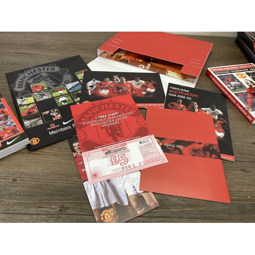 559 - A collection of Manchester United memorabilia comprising membership packs, magazines, year books and... 