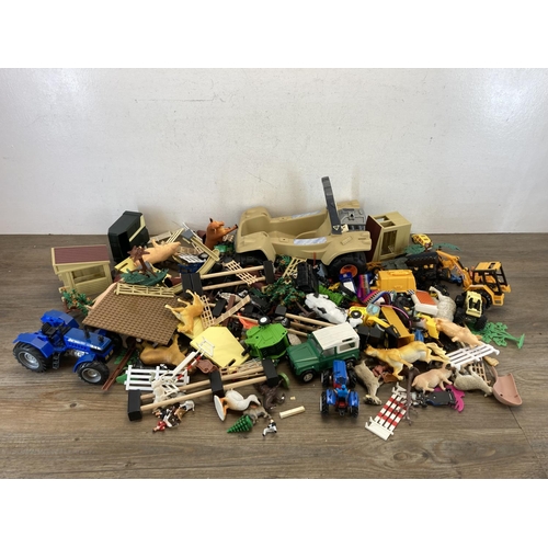 496 - A large collection of children's toys and accessories to include tractors, animals, outbuildings etc... 