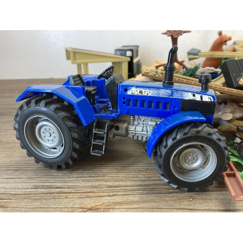 496 - A large collection of children's toys and accessories to include tractors, animals, outbuildings etc... 