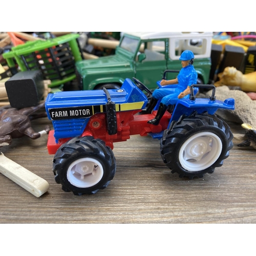 496 - A large collection of children's toys and accessories to include tractors, animals, outbuildings etc... 