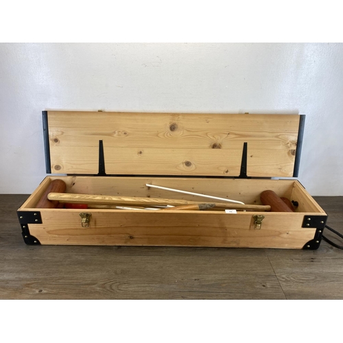 498 - A mid 20th century style pine cased croquet set