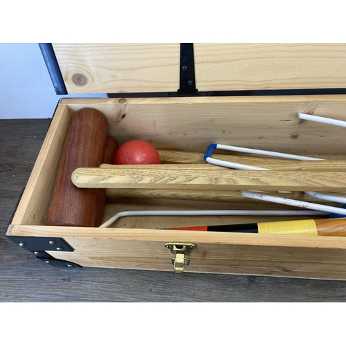 498 - A mid 20th century style pine cased croquet set