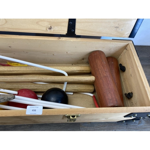 498 - A mid 20th century style pine cased croquet set