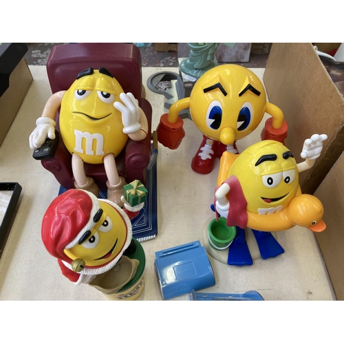 504 - Seven M&M's figurines together with one Pac-Man