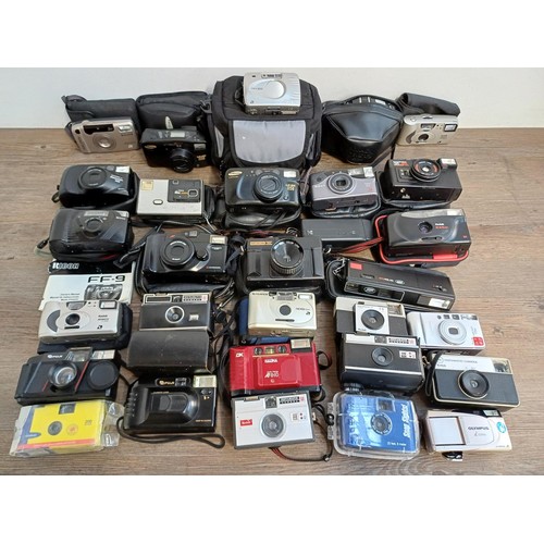 789 - A collection of cameras to include Canon, Yashica, Kodak, Fuji, Chinon, Halina, Ricoh, Hanimex etc.