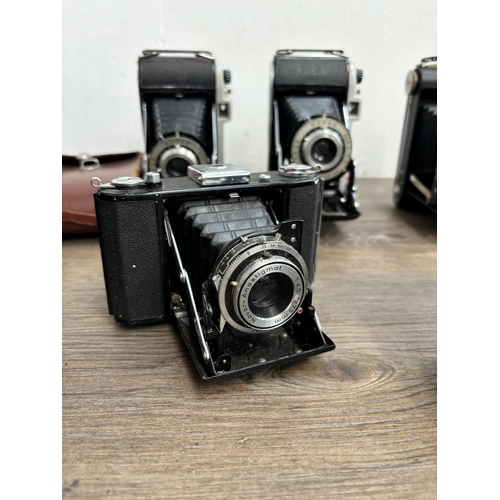 794 - Eleven folding cameras to include Zeiss Ikon Nettar 515/16, Voigtländer Bessa, Kodak Six-20 Junior m... 