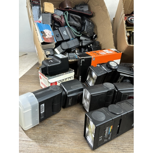 803 - Two boxes containing photography accessories to include flashes, filters, tripods, light meters, len... 