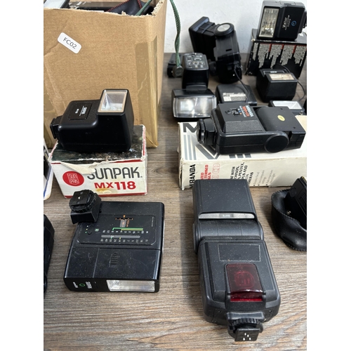 803 - Two boxes containing photography accessories to include flashes, filters, tripods, light meters, len... 