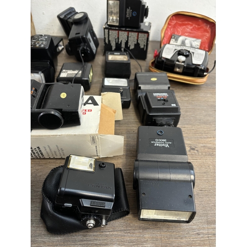 803 - Two boxes containing photography accessories to include flashes, filters, tripods, light meters, len... 