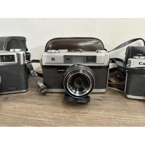 804 - Four 35mm rangefinder cameras, one Canon Canonet QL17 G-III, one cased Minolta A5, one cased Yashica... 