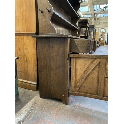 1 - A Nigel Griffiths carved oak dresser - approx. 165cm high x 167cm wide x 42cm deep