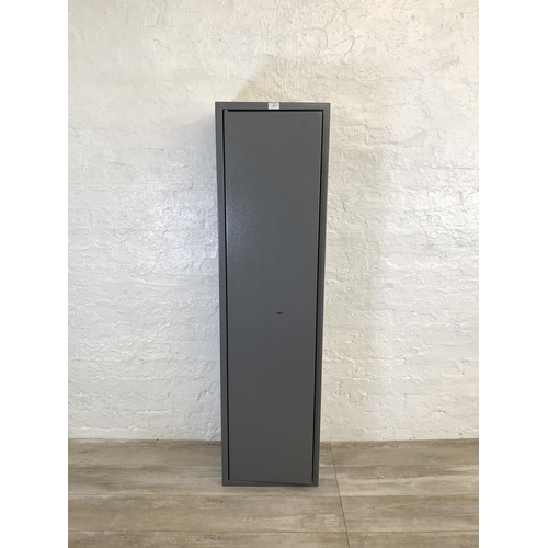 101 - A large grey metal gun cabinet - approx. 152cm high x 40cm wide x 33cm deep