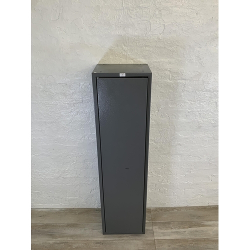 101 - A large grey metal gun cabinet - approx. 152cm high x 40cm wide x 33cm deep