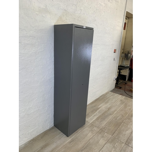 101 - A large grey metal gun cabinet - approx. 152cm high x 40cm wide x 33cm deep