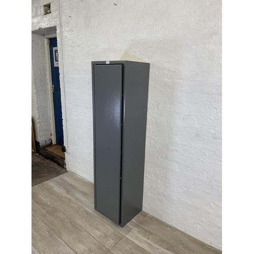 101 - A large grey metal gun cabinet - approx. 152cm high x 40cm wide x 33cm deep