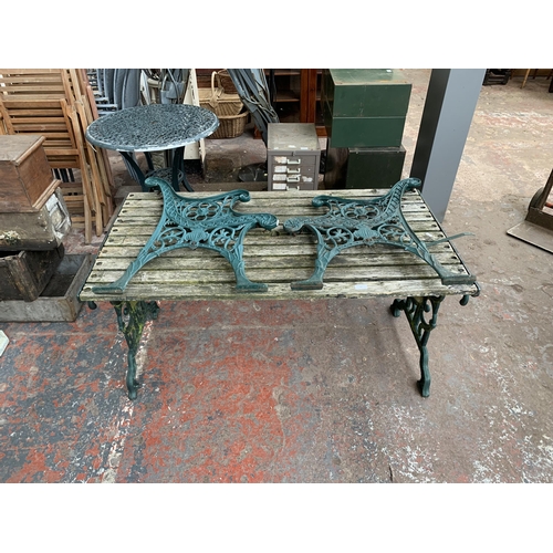 102 - Three pieces of garden furniture, one cast iron and green painted rectangular table and a pair cast ... 