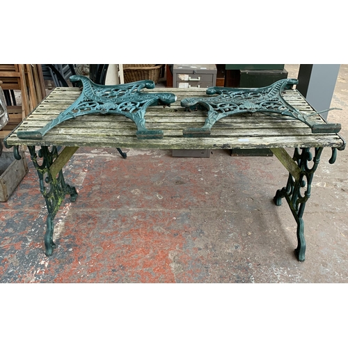 102 - Three pieces of garden furniture, one cast iron and green painted rectangular table and a pair cast ... 