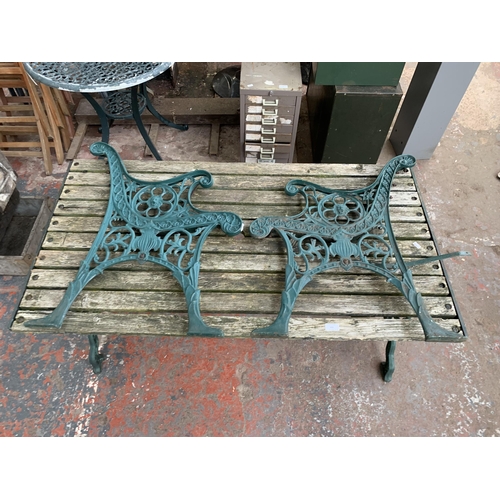 102 - Three pieces of garden furniture, one cast iron and green painted rectangular table and a pair cast ... 