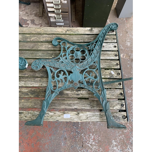 102 - Three pieces of garden furniture, one cast iron and green painted rectangular table and a pair cast ... 