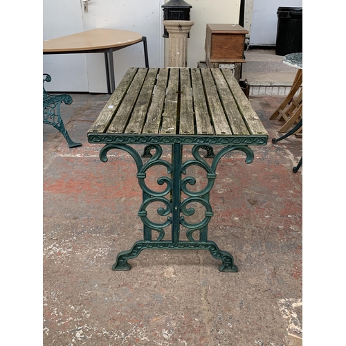 102 - Three pieces of garden furniture, one cast iron and green painted rectangular table and a pair cast ... 