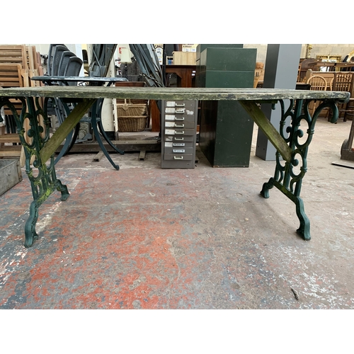 102 - Three pieces of garden furniture, one cast iron and green painted rectangular table and a pair cast ... 