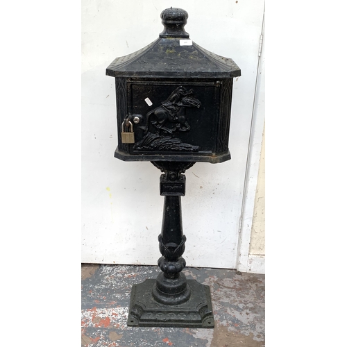 107 - A Victorian style cast iron and black painted post box on stand - approx. 117cm high