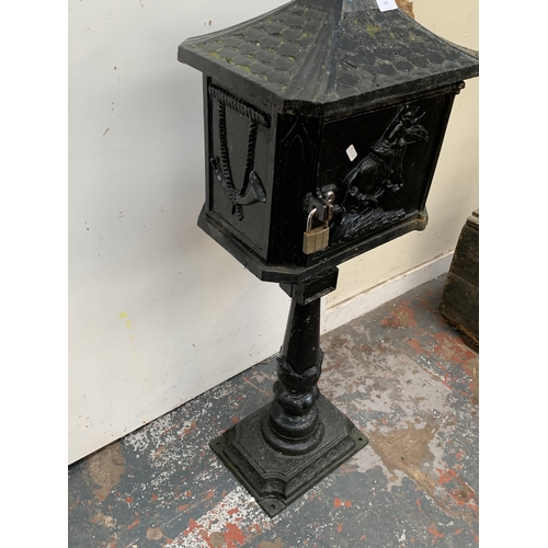 107 - A Victorian style cast iron and black painted post box on stand - approx. 117cm high