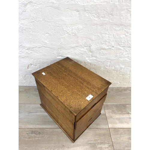 23 - A mid 20th century oak miniature desk top chest of four drawers - approx. 33.5cm high x 30cm wide x ... 