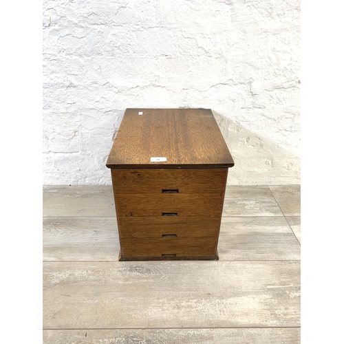 23 - A mid 20th century oak miniature desk top chest of four drawers - approx. 33.5cm high x 30cm wide x ... 