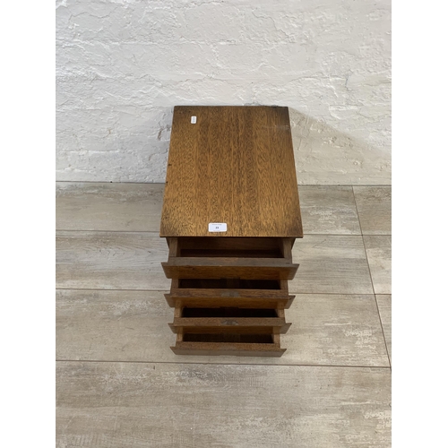 23 - A mid 20th century oak miniature desk top chest of four drawers - approx. 33.5cm high x 30cm wide x ... 