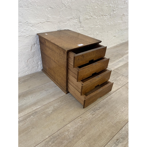 23 - A mid 20th century oak miniature desk top chest of four drawers - approx. 33.5cm high x 30cm wide x ... 