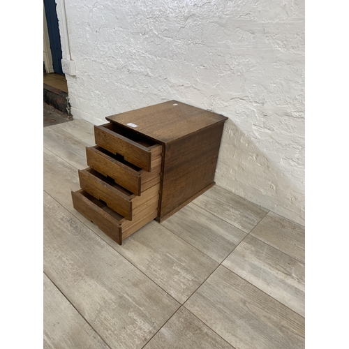 23 - A mid 20th century oak miniature desk top chest of four drawers - approx. 33.5cm high x 30cm wide x ... 