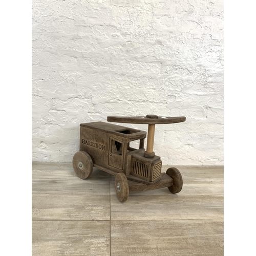 28 - Two items, one hand made wooden child's push along van and one vintage wicker child's armchair