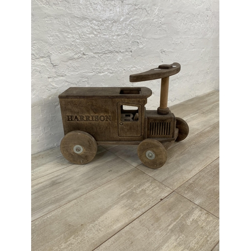 28 - Two items, one hand made wooden child's push along van and one vintage wicker child's armchair