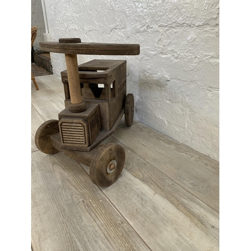 28 - Two items, one hand made wooden child's push along van and one vintage wicker child's armchair