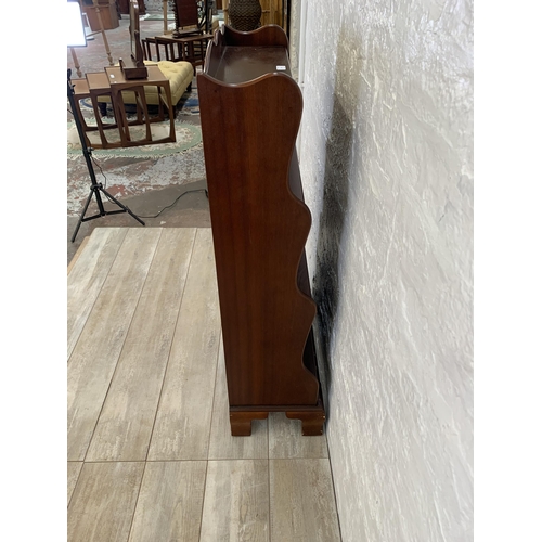 29 - A J. Sydney Smith mahogany waterfall free-standing bookcase - approx. 113cm high x 57cm wide