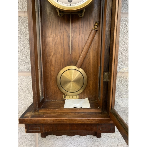 38 - An early/mid 20th century oak chiming wall clock - approx. 88cm high x 31cm wide